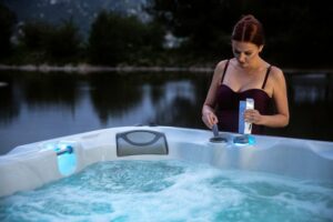 Hot Tub Aromatherapy - Woman Adding Sunscents To A Sundance®️ Spa