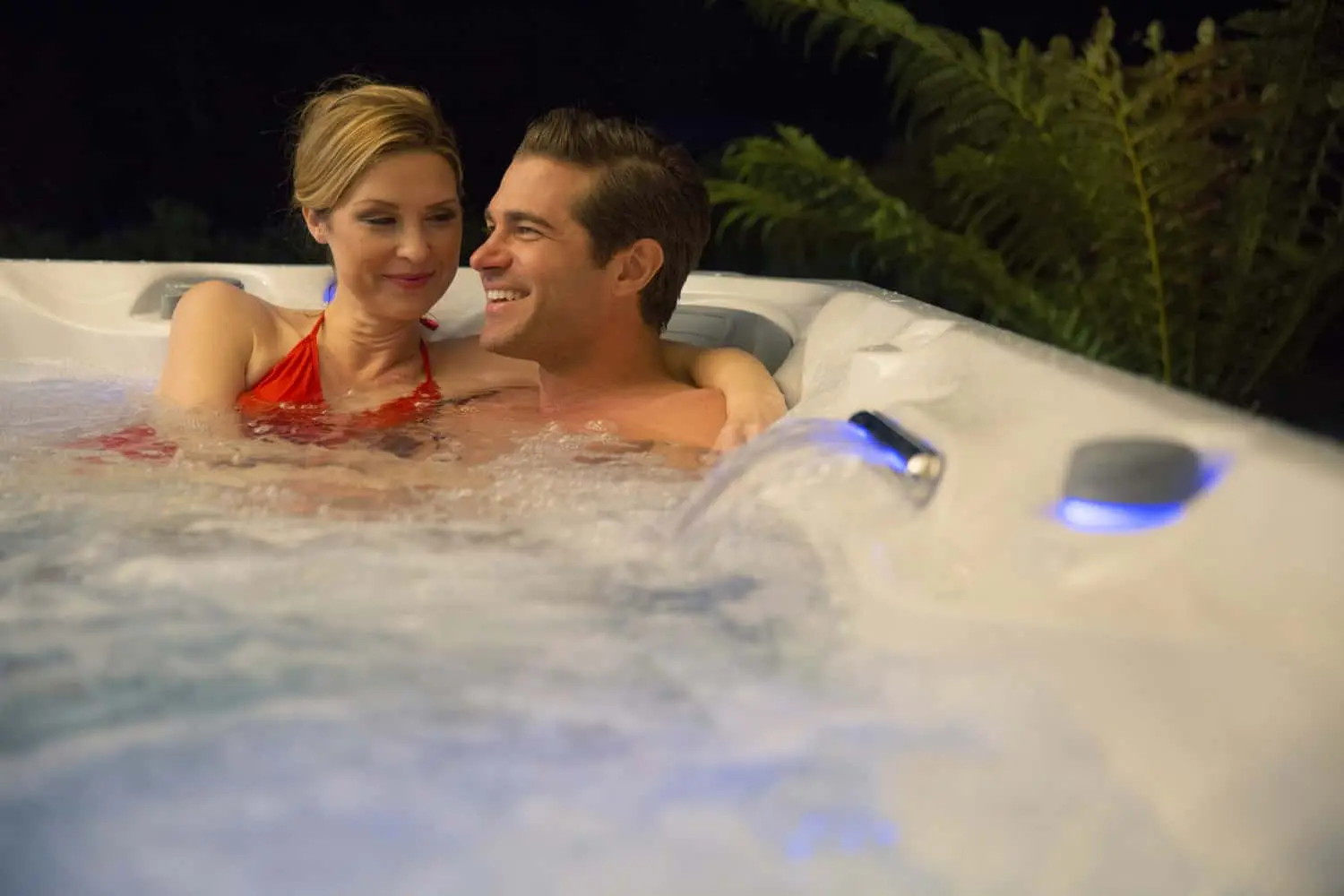 Women Relaxing With Her Husband In The Hot Tub At Night