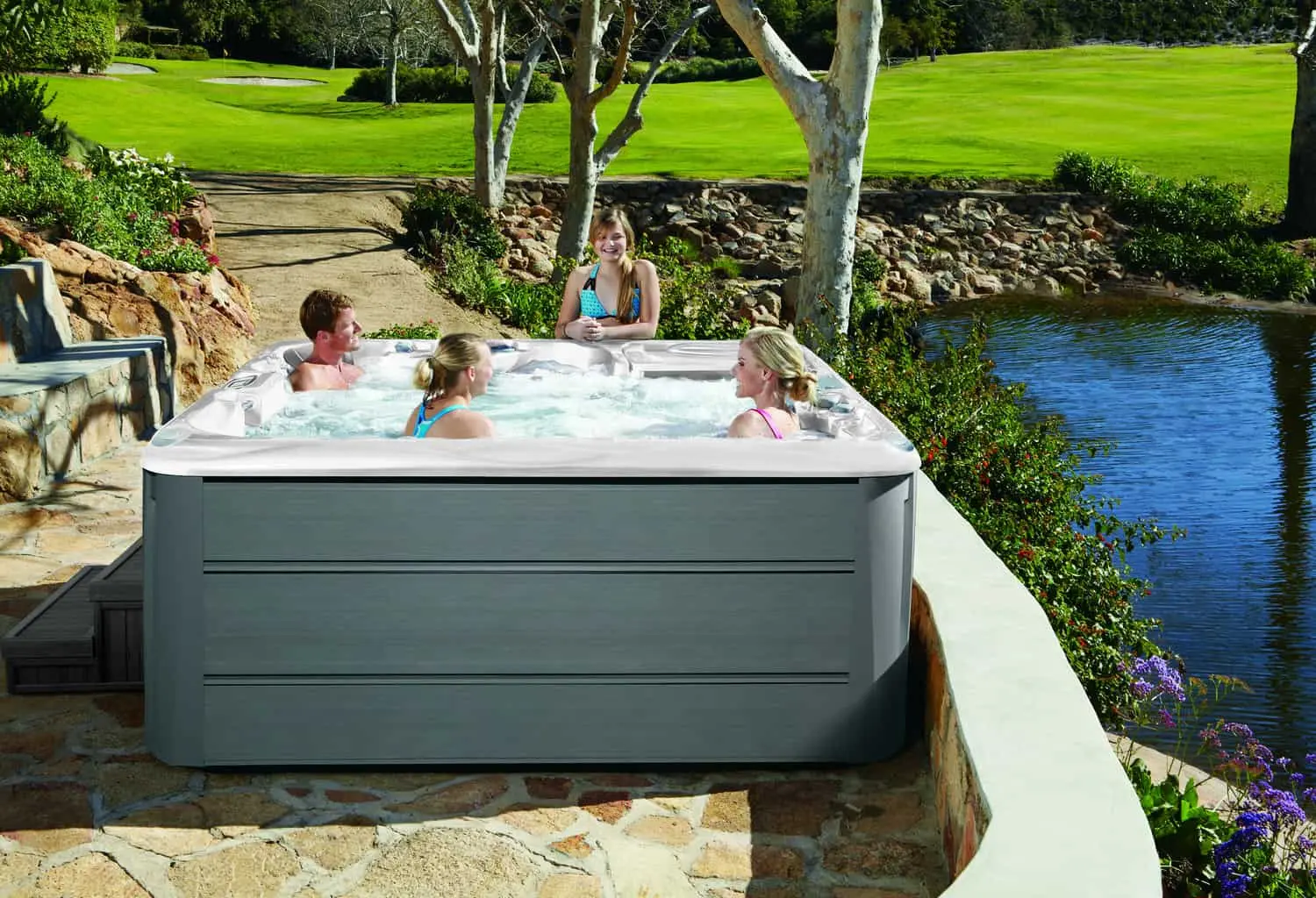 A Family Of 4 Relax In The Hot Tub From Sundance Spas