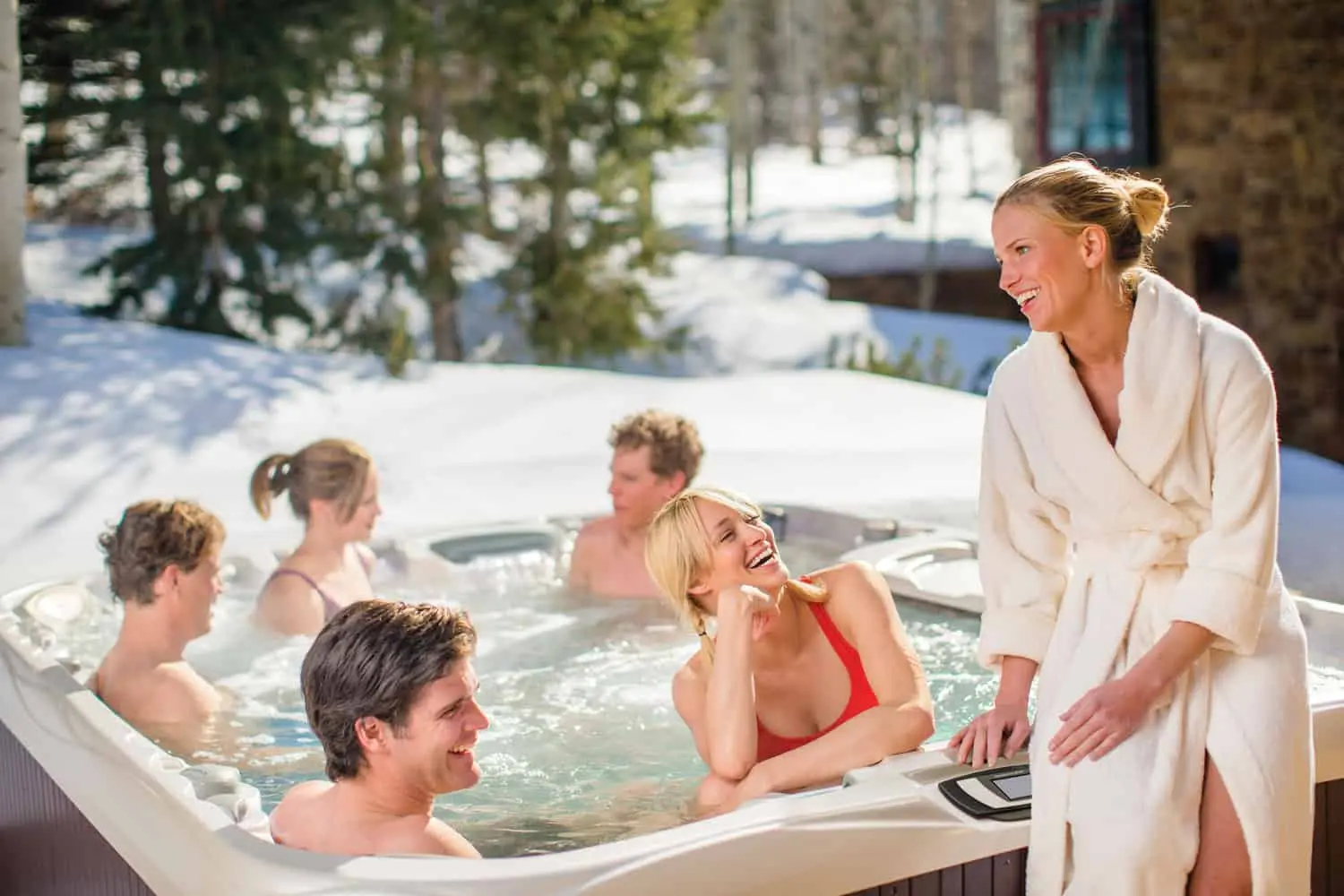 Six People Enjoying The Hot Tub From Sundance Spas In The Winter