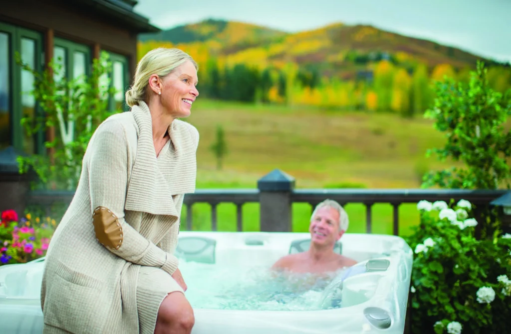 an elderly couple enjoying time in the hot tub after working in the garden